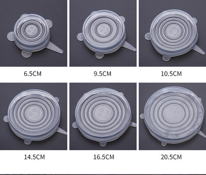 Five transparent silicone lids in different sizes with circular ridges on a dark background.