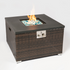 Square wicker fire pit with black top, blue and white stones, and bright orange flames.