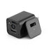 Black adapter with USB port, camera lens, and removable cover lying on a white background.