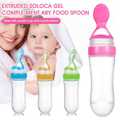 Three baby food spoons in blue, orange, and green with suction bases, and a mother with a child.