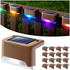 Brown solar deck lights emitting rainbow colors, arranged on a wooden fence.