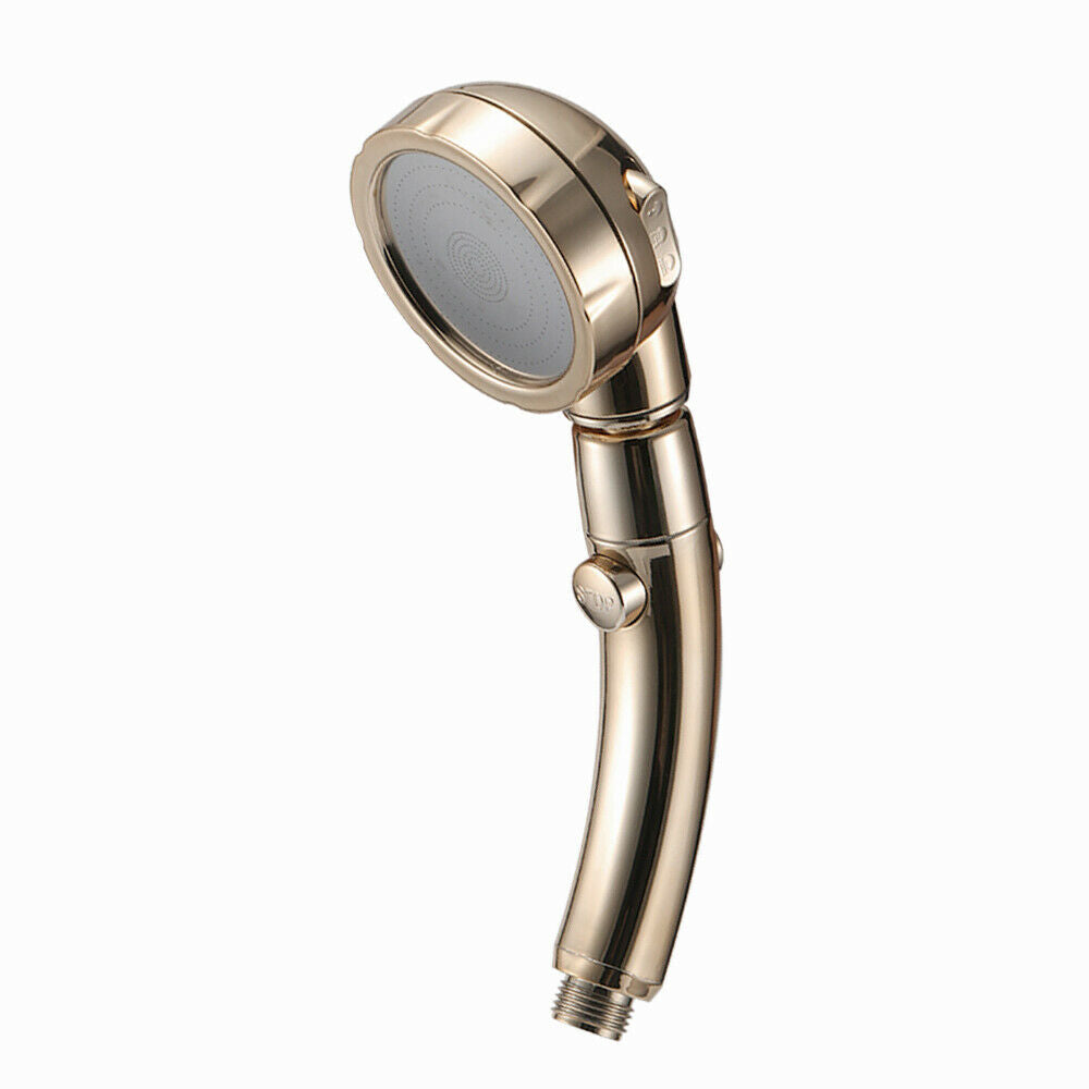 Gold handheld shower head with a round face and curved handle on a white background.