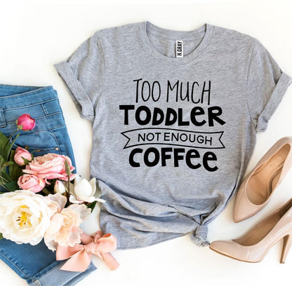 Gray t-shirt with "Too Much Toddler, Not Enough Coffee" text, jeans, flowers, and beige heels.