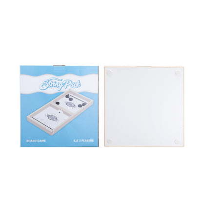 Board game box with blue background, "String Puck" text, and a white, square game board beside it.
