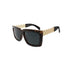 Tortoiseshell sunglasses with dark lenses and gold crisscrossed arms on a white background.