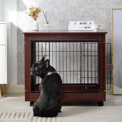 Black dog sitting in front of a brown wooden crate with decorative items on top.