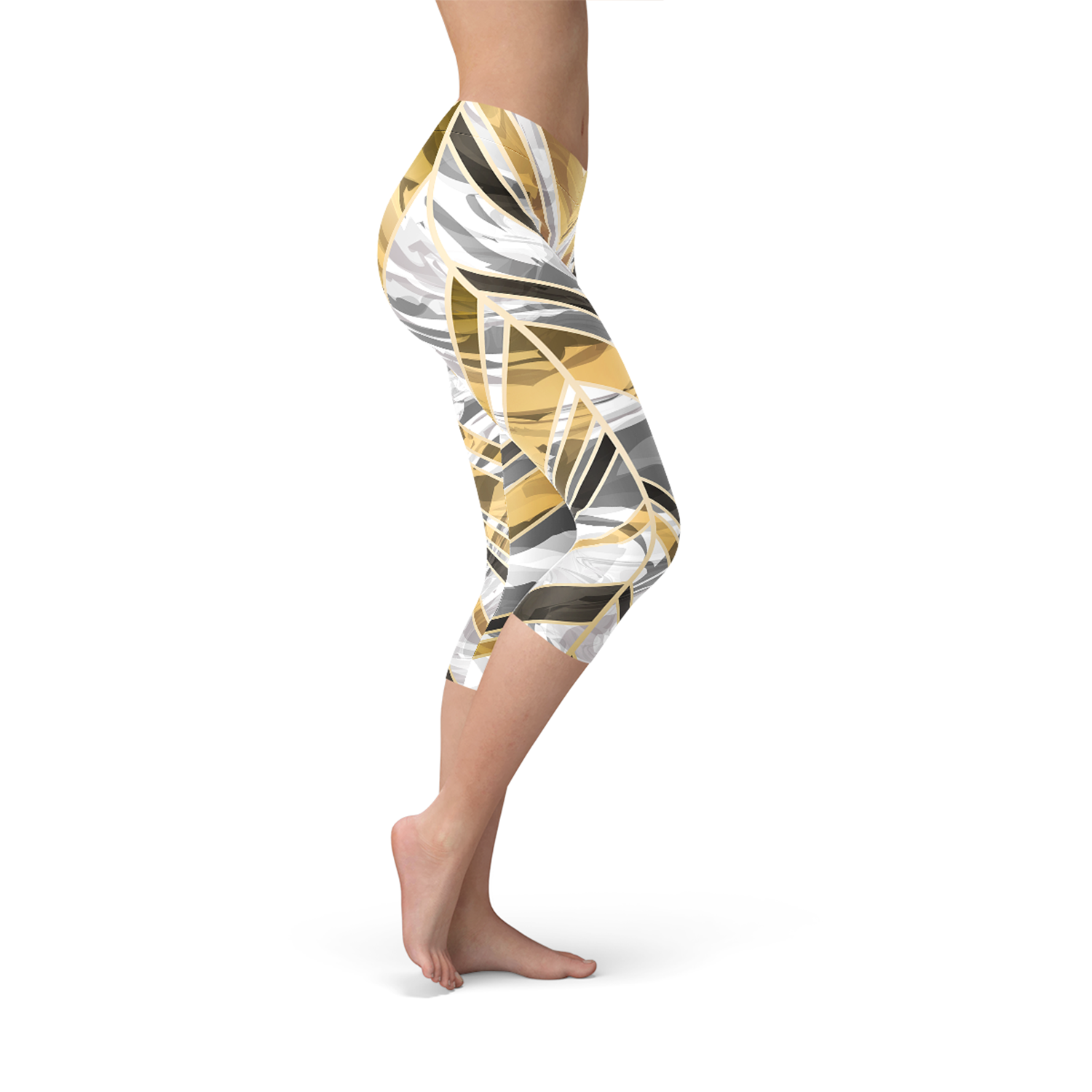 Woman side view wearing abstract yellow, gray, and white patterned capri leggings, barefoot.