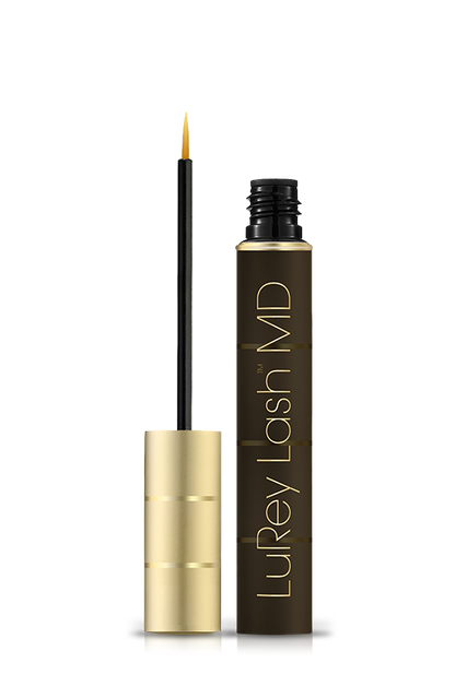 Gold and black eyelash serum bottle, open with a thin applicator wand beside it.