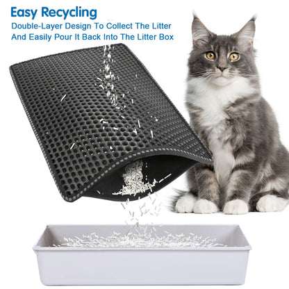 Gray cat beside a black dual-layer litter mat pouring white litter into a white box.