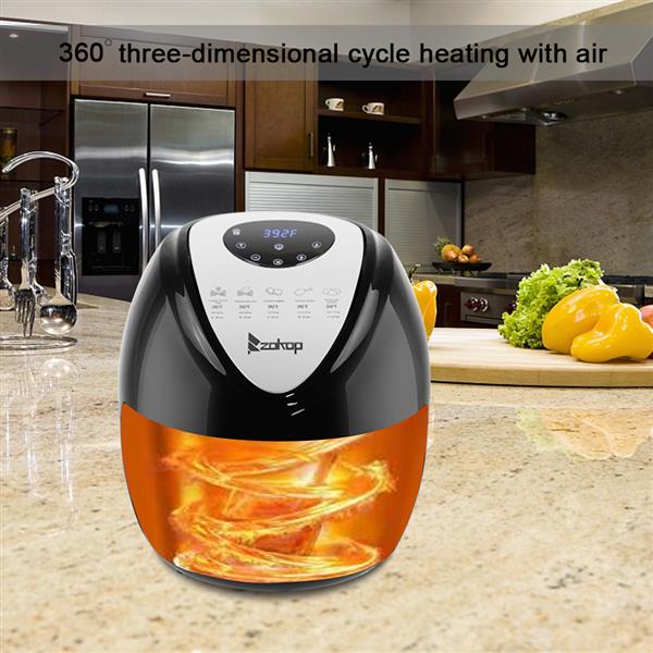 Black air fryer with digital display and orange heat swirl, on a kitchen counter with vegetables.