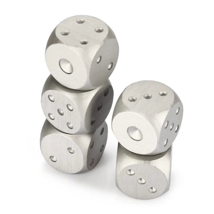 Four stainless steel dice stacked, showing smooth metallic finish and engraved dots.