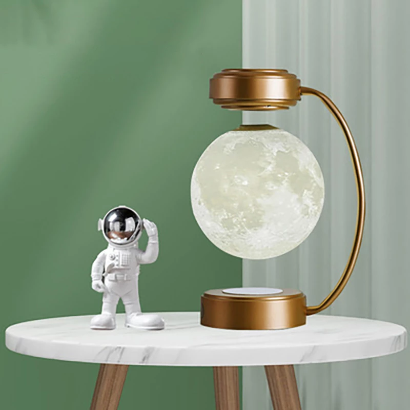 Astronaut figure and moon lamp on round table with green background and bronze stand.