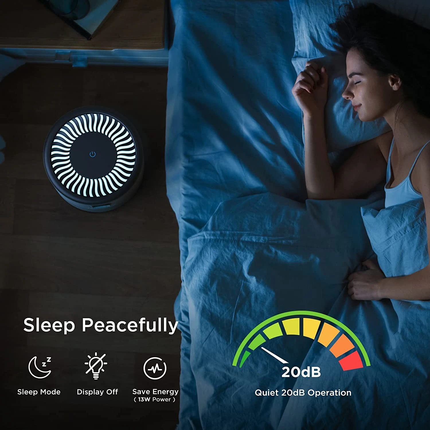 Woman sleeping peacefully in a bed with blue sheets, next to a glowing circular device on the floor.