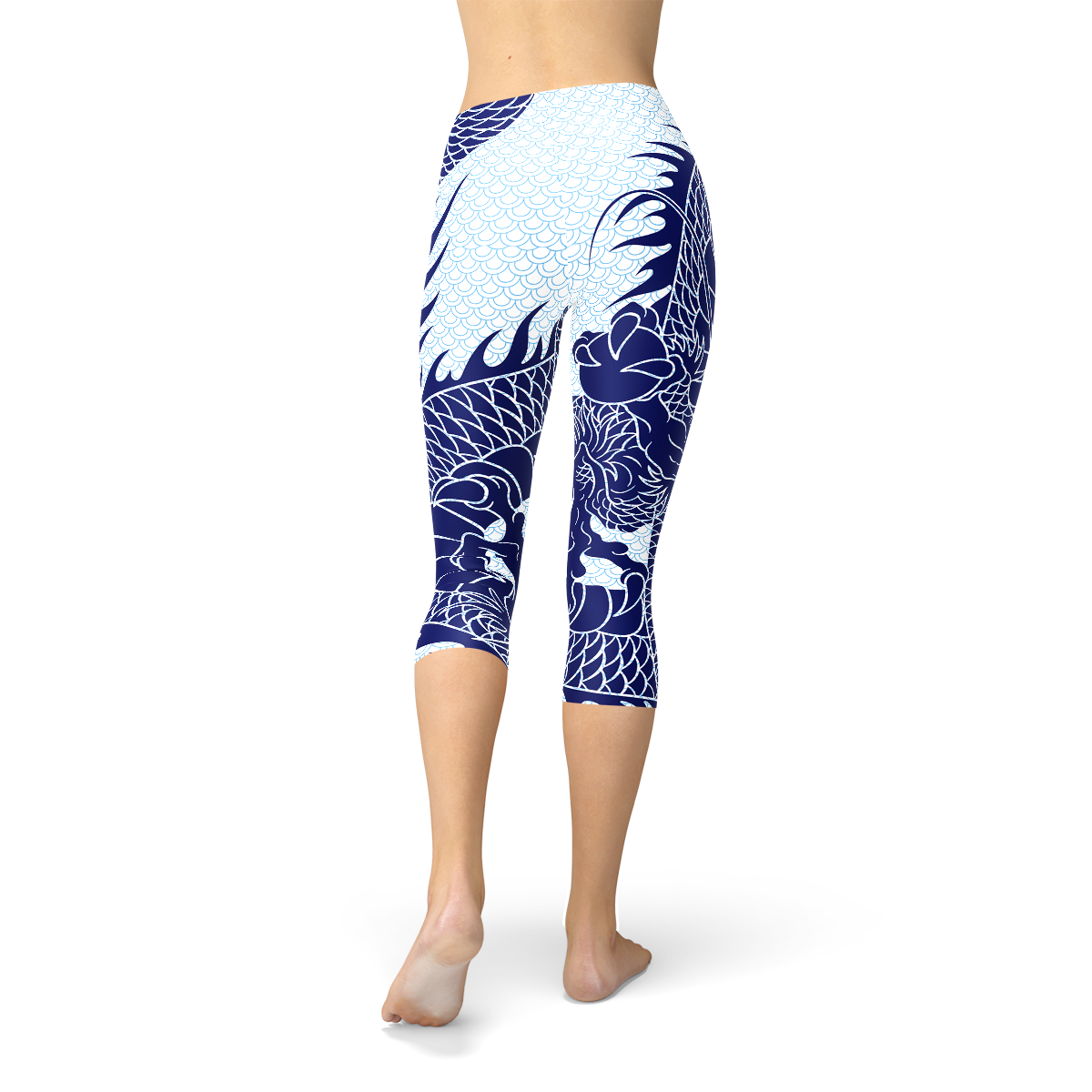 Blue leggings with white dragon and wave patterns, worn by a person standing barefoot.