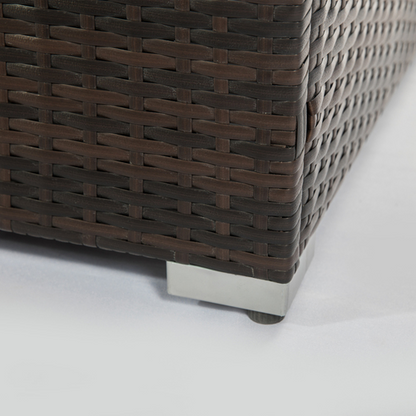 Close-up of brown wicker furniture corner with silver metal leg on a light surface.