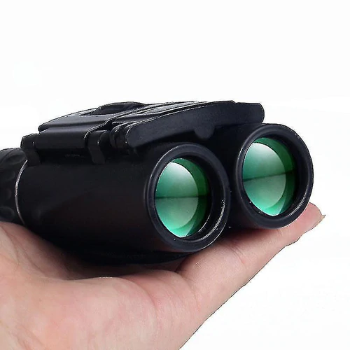 Black binoculars with green lenses held in a person&