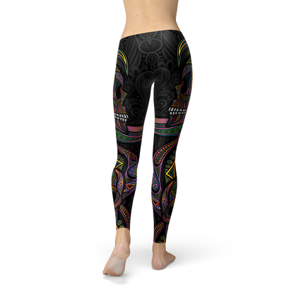 Colorful sugar skull design leggings with intricate patterns on a black background.