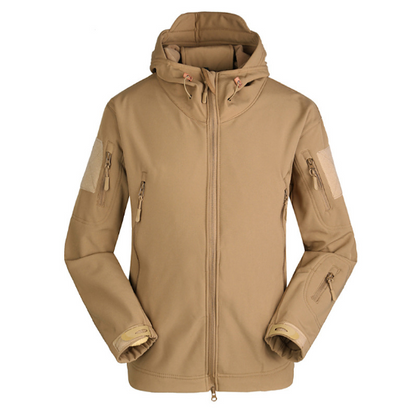 Tan hooded jacket with multiple zipper pockets, velcro patches on sleeves, and adjustable cuffs.