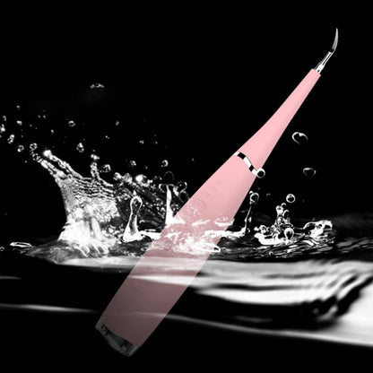 Pink dental tool splashing in water against a black background.