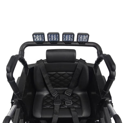 Black seat with diamond stitching, harness, and overhead LED lights on a bar frame.