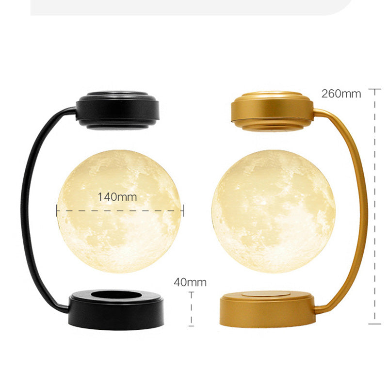 Two floating moon lamps; one with a black base, the other gold; both with curved stands.