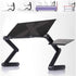Adjustable black laptop stand with perforated surface, angled legs, and additional small platform.
