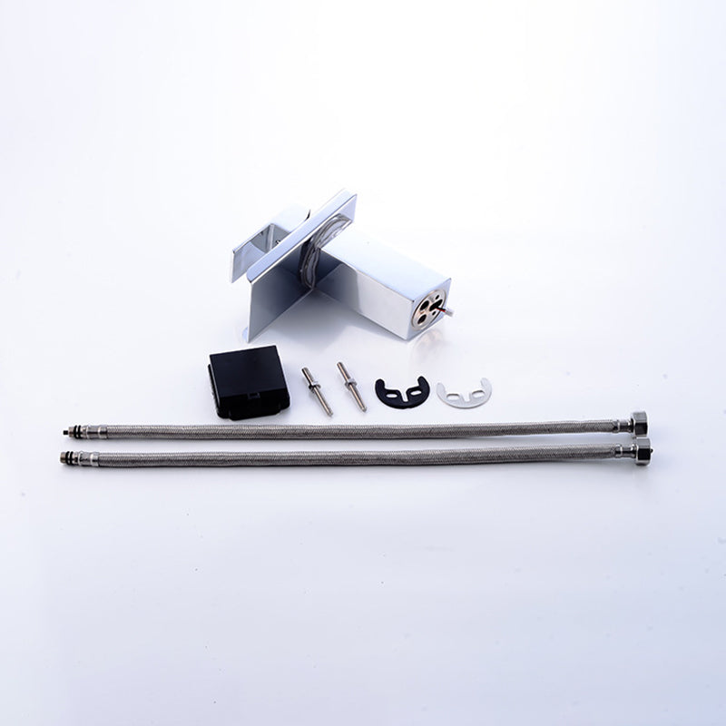 Silver faucet parts on a white background, including hoses, screws, and a black component.