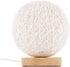 White string orb lamp on a wooden base with intricate crisscross design.