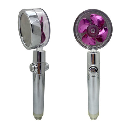 Shiny silver showerheads with clear covers and pink propellers inside, shown from front and side.