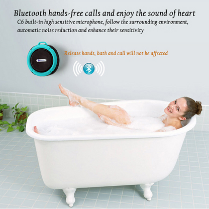 Woman smiling in a white clawfoot bathtub, with a blue Bluetooth speaker on the wall.