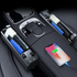 Car console with organized storage compartments, black and gray tones, phone charging on console.