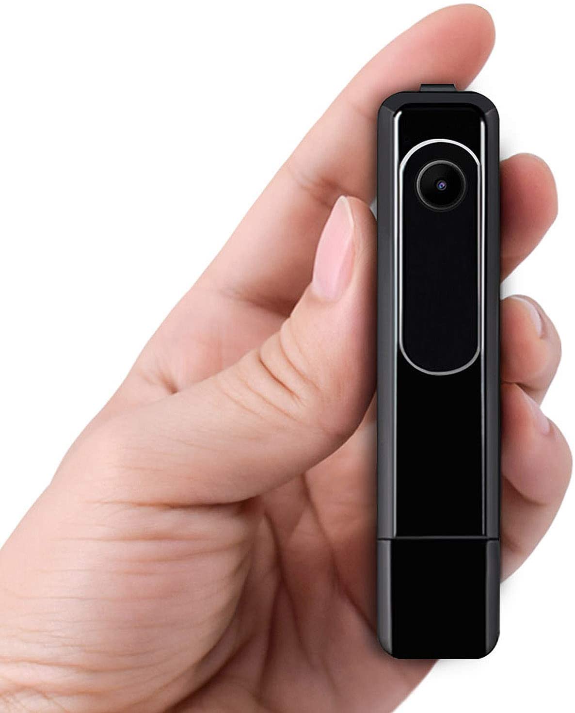 Hand holding a small, rectangular black camera device with a lens on the front.