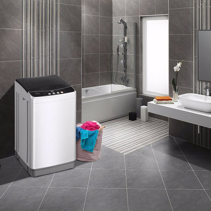 Modern bathroom with gray tiles, white washing machine, and a basket with colorful towels.