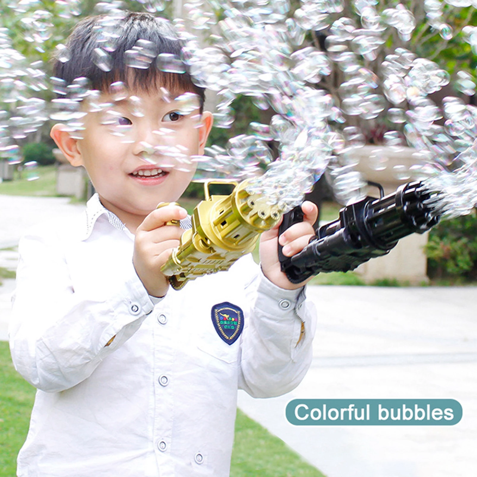 Child in a white shirt playing with bubble guns, emitting numerous colorful bubbles outdoors.