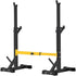Squat rack with black frame, yellow support bar, and angled weight holders.