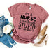 Pink T-shirt with humorous text, paired with ripped jeans and beige high heels.