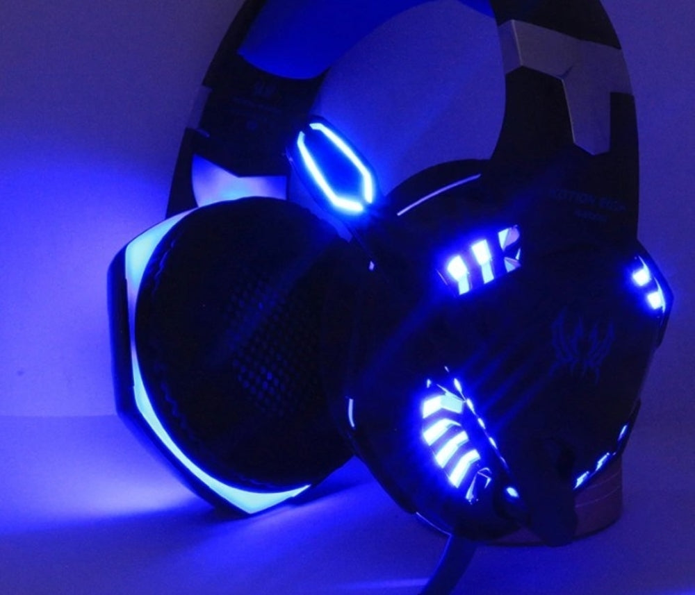 Futuristic black headphones with bright blue LED lights glowing in the dark.