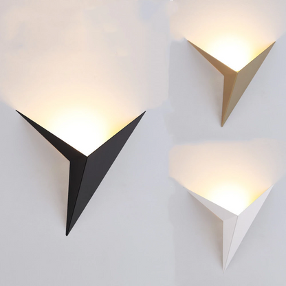 Triangular wall lights in black, gold, and white emit soft upward glows on a white background.