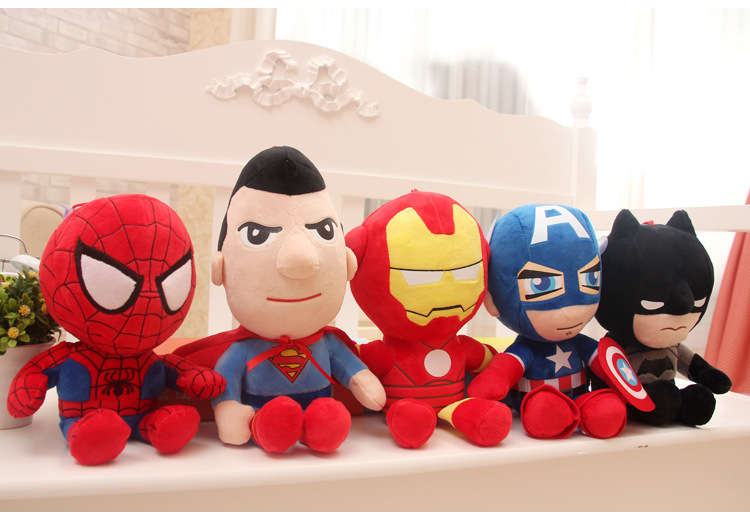 Five superhero plush toys in vibrant colors: red, blue, yellow, and black, sitting in a row.