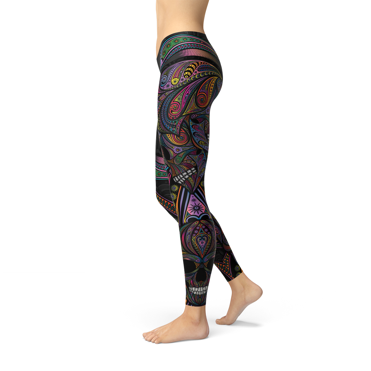 Legs wearing vibrant, patterned leggings with swirling paisley and skull designs on a black background.