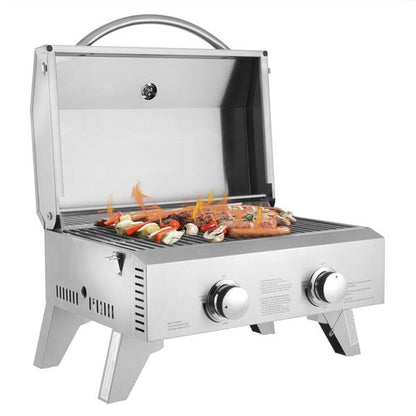 Stainless steel grill with open lid; skewers and meat cooking over flames, two control knobs.