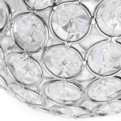 Close-up of a metallic circular pattern with clear crystal-like discs on a white background.