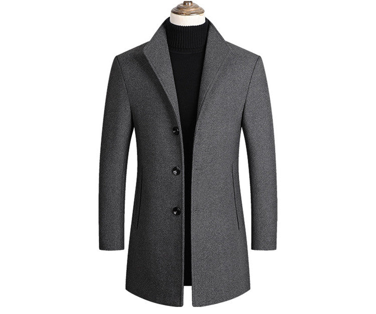 Gray overcoat with black buttons on a mannequin, featuring a black collarless top underneath.