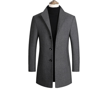Gray overcoat with black buttons on a mannequin, featuring a black collarless top underneath.