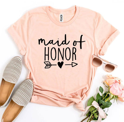 Peach "Maid of Honor" t-shirt with arrow and heart, paired with tan shoes, sunglasses, and roses.