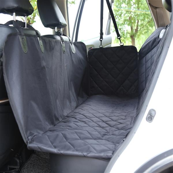 Black quilted car seat cover in a backseat, attached to headrests, with an open car door.