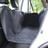 Black quilted car seat cover in a backseat, attached to headrests, with an open car door.