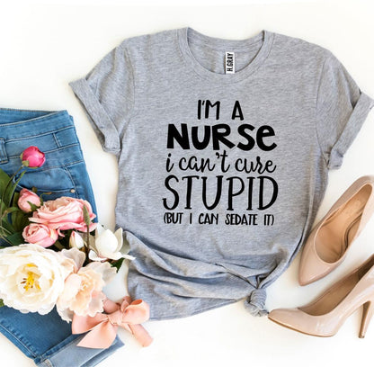 Gray T-shirt with text, blue jeans, beige heels, and pink-white flowers on a white background.