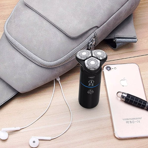 A black electric shaver beside a gray bag, white earbuds, and a smartphone on a wooden surface.