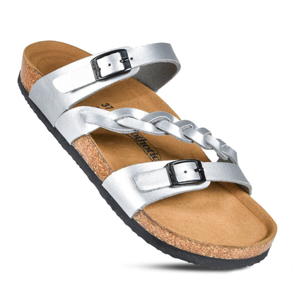 Silver strappy sandal with black buckles, brown cork footbed, and black sole.